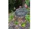Serenbe Lane address sign with blooming pink roses in landscaped flower bed at 10540 Serenbe Ln, Chattahoochee Hills, GA 30268