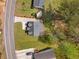Aerial view of the property showcasing the home's layout, driveway, and surrounding greenery at 1071 N Price Rd, Sugar Hill, GA 30518