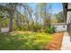 Lush backyard with mature trees, offering a serene and private outdoor space at 1071 N Price Rd, Sugar Hill, GA 30518
