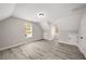 Charming bedroom with wood floors, dormer windows, and neutral paint, perfect for a relaxing retreat at 1071 N Price Rd, Sugar Hill, GA 30518
