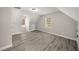 Spacious bedroom with wood flooring, dormer windows, and neutral paint, offering a bright and airy atmosphere at 1071 N Price Rd, Sugar Hill, GA 30518