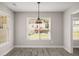 Inviting dining area featuring large windows and modern pendant lighting at 1071 N Price Rd, Sugar Hill, GA 30518
