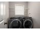 Convenient laundry room with side by side washer and dryer and natural light at 1071 N Price Rd, Sugar Hill, GA 30518