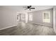 A view of the airy living room featuring updated flooring and multiple windows at 1071 N Price Rd, Sugar Hill, GA 30518