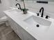 Bathroom featuring a double sink vanity with white countertops and matte black hardware at 115 Dahlia Nw Ave, Atlanta, GA 30314