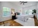 Cozy primary bedroom featuring hardwood floors, a decorative rug, two windows, and neutral decor at 115 Dahlia Nw Ave, Atlanta, GA 30314