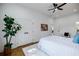 Bright bedroom featuring a ceiling fan, hardwood floors, a large closet, and a cozy rug at 115 Dahlia Nw Ave, Atlanta, GA 30314