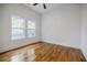 Spacious bedroom features hardwood floors, two large windows, neutral white walls, and white trim at 115 Dahlia Nw Ave, Atlanta, GA 30314