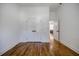 Bright bedroom featuring hardwood floors, white trim, and view to hallway with white doors at 115 Dahlia Nw Ave, Atlanta, GA 30314