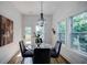 Elegant dining room featuring a marble table, chandelier, and natural lighting at 115 Dahlia Nw Ave, Atlanta, GA 30314
