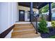 Inviting front porch with stairs and black railings, perfect for relaxing outdoors at 115 Dahlia Nw Ave, Atlanta, GA 30314