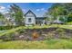 Charming two-story home featuring a landscaped front yard with an inviting curb appeal at 115 Dahlia Nw Ave, Atlanta, GA 30314