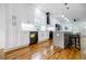 Updated kitchen with stainless steel appliances, quartz countertops, an island, and access to the living area at 115 Dahlia Nw Ave, Atlanta, GA 30314