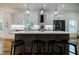 Modern kitchen featuring an island with seating, pendant lighting, stainless steel appliances, and white cabinetry at 115 Dahlia Nw Ave, Atlanta, GA 30314