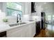Modern kitchen featuring white cabinets, quartz countertops, black hardware, and stainless steel appliances at 115 Dahlia Nw Ave, Atlanta, GA 30314