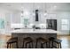 Bright kitchen with a gray island, white cabinets, stainless steel appliances, and hardwood floors at 115 Dahlia Nw Ave, Atlanta, GA 30314