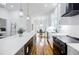 Bright, updated kitchen with large island, white cabinets, stainless steel appliances, and view to dining area at 115 Dahlia Nw Ave, Atlanta, GA 30314