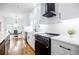 Modern kitchen with white cabinetry, stainless steel appliances, and black hardware at 115 Dahlia Nw Ave, Atlanta, GA 30314