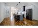 Open-concept kitchen with a large island, modern appliances, and hardwood floors at 115 Dahlia Nw Ave, Atlanta, GA 30314