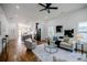 Open-concept living room and kitchen with hardwood floors and modern lighting at 115 Dahlia Nw Ave, Atlanta, GA 30314