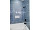 Close-up of a blue tiled shower with rainfall shower head and built-in niche at 115 Dahlia Nw Ave, Atlanta, GA 30314