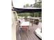 Back deck with a dining table, chairs, and a cantilever umbrella overlooking a well-maintained backyard at 124 Gorham Gates Ct, Hiram, GA 30141