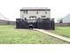 Backyard featuring a dark wood deck with stairs down to a grill and large grassy space at 124 Gorham Gates Ct, Hiram, GA 30141