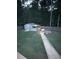 Backyard featuring a long stone walkway to the shed, a firepit, landscaping, and forest views at 124 Gorham Gates Ct, Hiram, GA 30141