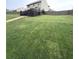 Large backyard with a long stone walkway leading toward the dark wood deck with stairs at 124 Gorham Gates Ct, Hiram, GA 30141