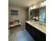 Bright bathroom featuring double sinks, a large mirror, and a decorative painting at 124 Gorham Gates Ct, Hiram, GA 30141
