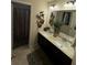 Bathroom featuring a double sink vanity, stylish fixtures, decorative mirror, and neutral color palette at 124 Gorham Gates Ct, Hiram, GA 30141