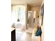 Bathroom featuring a walk in shower, soaking tub and stylish decor; neutral color palette with natural light at 124 Gorham Gates Ct, Hiram, GA 30141
