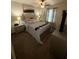 Comfortable bedroom featuring soft lighting, carpeted floors, and a ceiling fan at 124 Gorham Gates Ct, Hiram, GA 30141