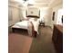 Bedroom with a wooden four-poster bed, neutral walls, a ceiling fan, and lots of natural light at 124 Gorham Gates Ct, Hiram, GA 30141