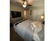Well-lit bedroom featuring a ceiling fan and a television mounted on a dresser at 124 Gorham Gates Ct, Hiram, GA 30141