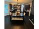 Charming dining area showcasing dark wood floors, unique lighting, and a chalkboard accent wall at 124 Gorham Gates Ct, Hiram, GA 30141