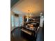 Cozy dining area featuring dark wood floors, stylish light fixture, and a bench for seating at 124 Gorham Gates Ct, Hiram, GA 30141