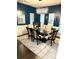 Stylish dining area featuring dark wood floors, modern light fixture, and elegant decor, perfect for gatherings at 124 Gorham Gates Ct, Hiram, GA 30141