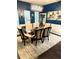 Elegant dining room featuring dark wood floors, modern chandelier, and stylish decor at 124 Gorham Gates Ct, Hiram, GA 30141