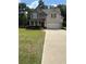 Charming two-story home with a manicured lawn, brick accents, and a welcoming front porch at 124 Gorham Gates Ct, Hiram, GA 30141
