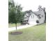 Well-maintained two-story home with a two-car garage, landscaped yard, and mature trees at 124 Gorham Gates Ct, Hiram, GA 30141