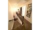 Upstairs hallway view featuring a dark-stained wood railing and wall art at 124 Gorham Gates Ct, Hiram, GA 30141