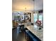 Open kitchen concept view with granite countertops, island seating, and view to the living room at 124 Gorham Gates Ct, Hiram, GA 30141