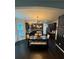 Open concept kitchen and dining area with dark cabinetry and hardwood floors at 124 Gorham Gates Ct, Hiram, GA 30141