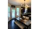 Bright eat-in kitchen with a stylish chandelier, dark cabinets, and a cozy dining space at 124 Gorham Gates Ct, Hiram, GA 30141