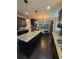 Modern kitchen featuring granite countertops, dark cabinetry, stainless steel appliances, and an island with seating at 124 Gorham Gates Ct, Hiram, GA 30141