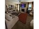 Cozy living room with large sectional couch, fireplace and accent rug at 124 Gorham Gates Ct, Hiram, GA 30141
