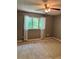 Neutral bedroom featuring a ceiling fan, large window, and plush carpeting at 1807 Ashborough Se Cir # B, Marietta, GA 30067