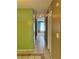 Hallway leading to a carpeted room with bright green walls and tiled floors at 1807 Ashborough Se Cir # B, Marietta, GA 30067