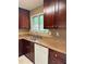 Kitchen with stainless steel sink, window, and dark wood cabinets at 1807 Ashborough Se Cir # B, Marietta, GA 30067